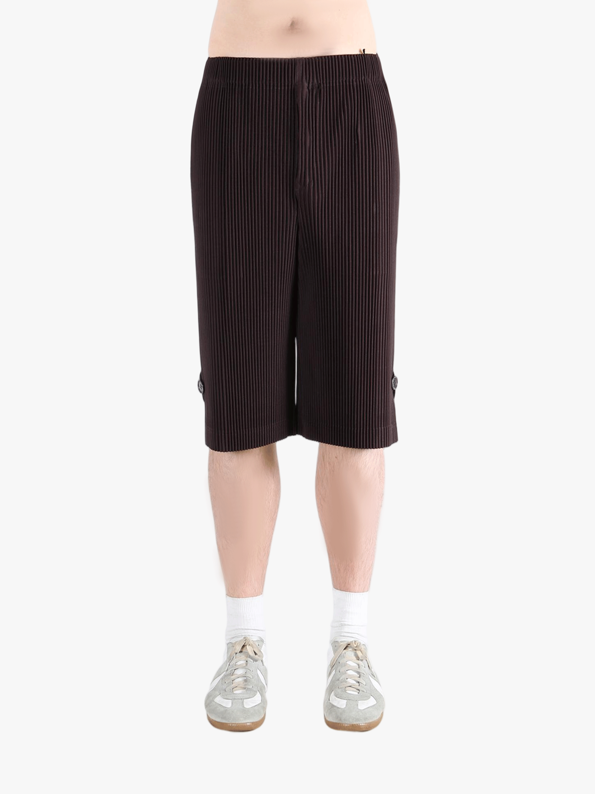 Black pants worn by a person, showing the pant's fit