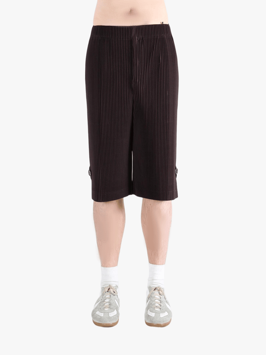 Black pants worn by a person, showing the pant's fit