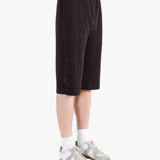 Black pants worn by a person, showing the pant's fit