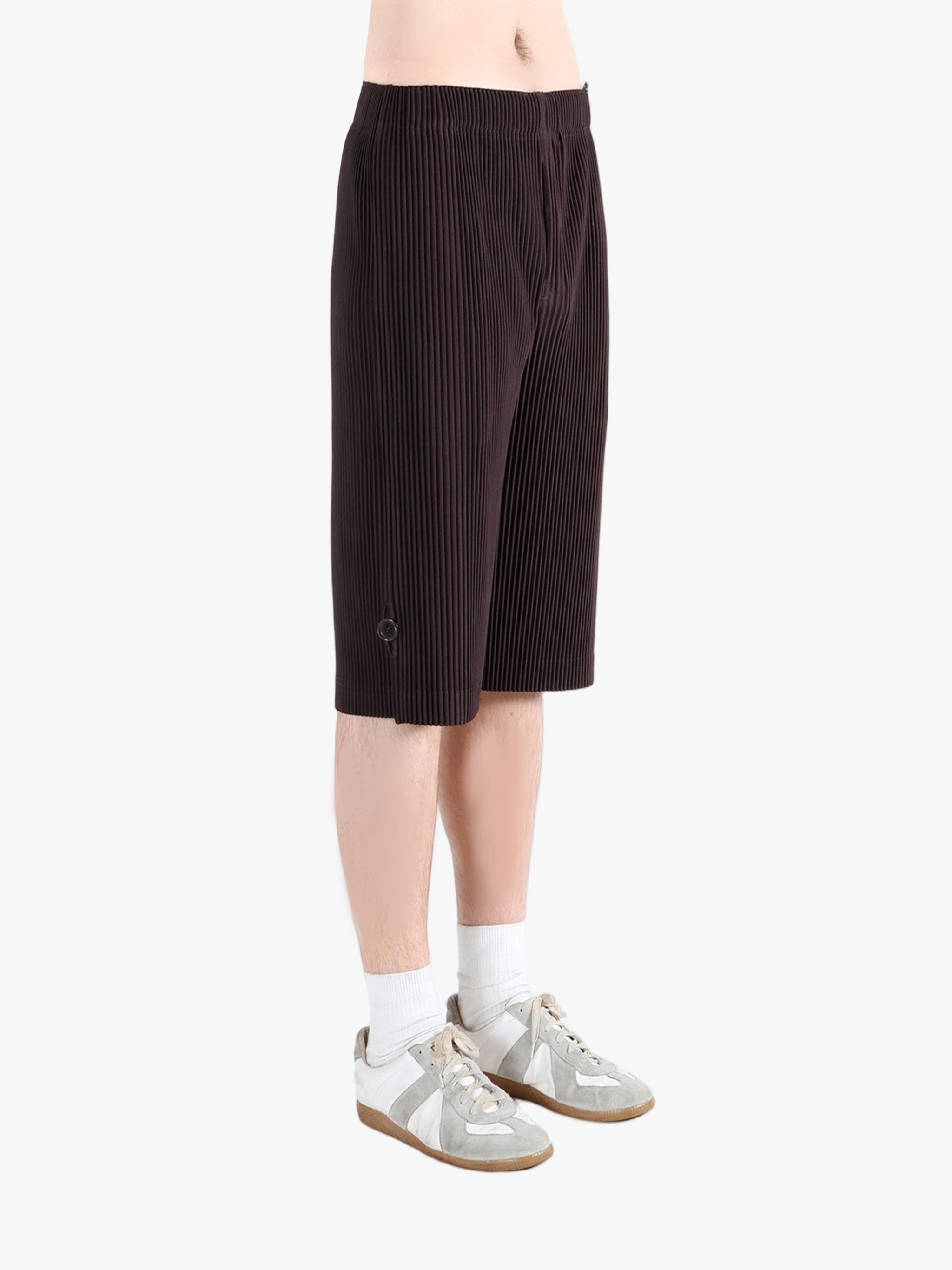 Black pants worn by a person, showing the pant's fit