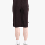 Black pants worn by a person, showing the pant's fit