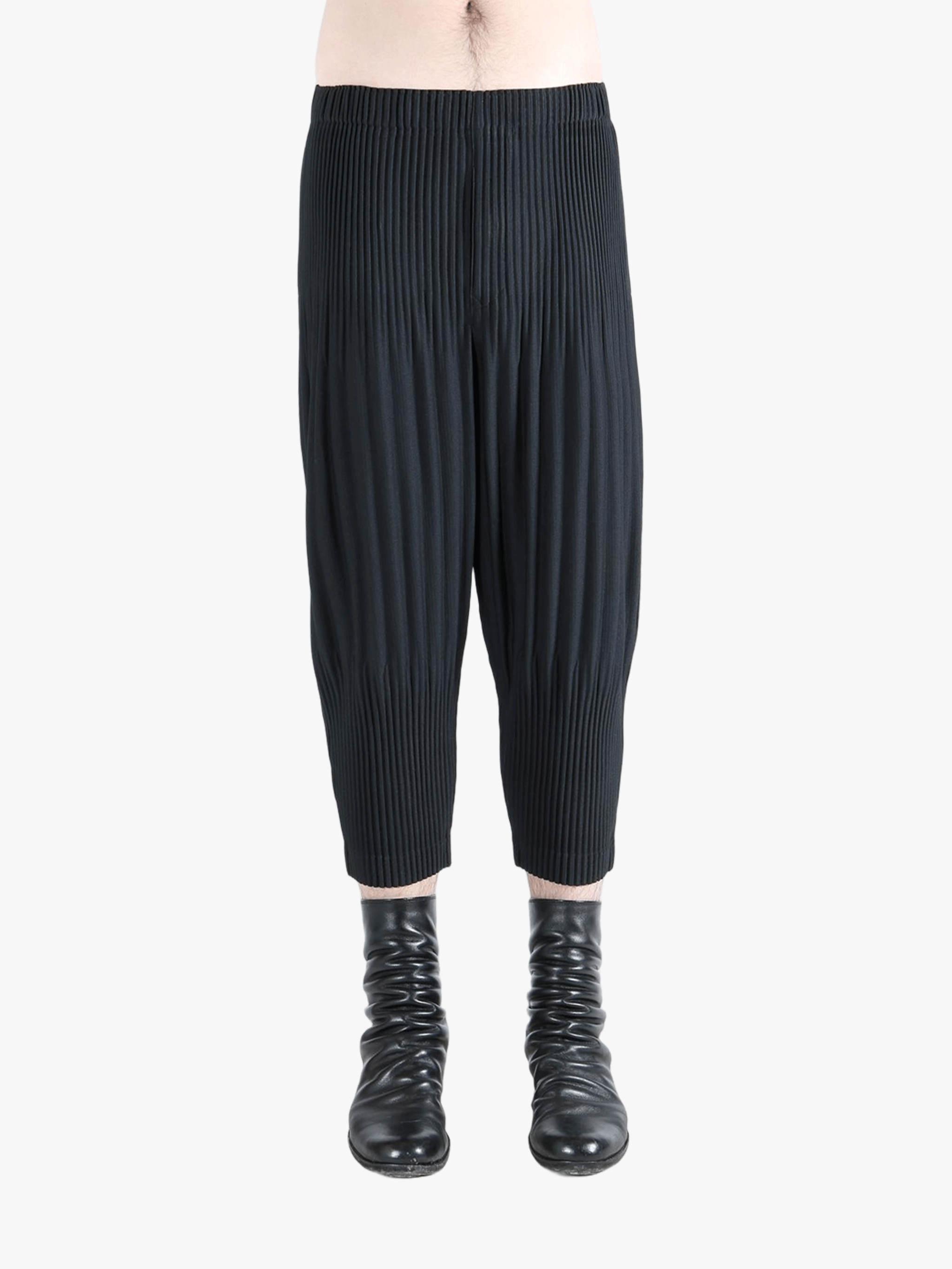 Black pants worn by a person,showing the pants fit