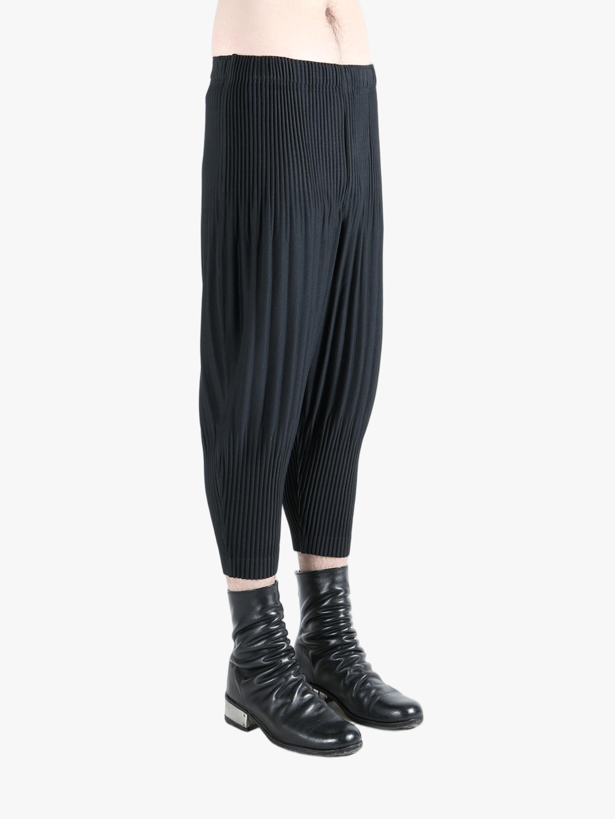 Black pants worn by a person,showing the pants fit