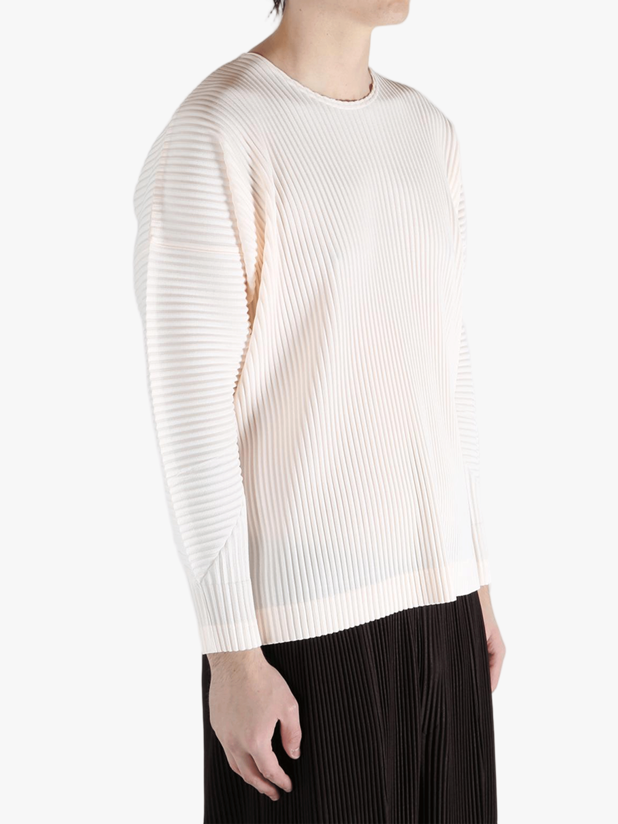 White top worn by a person,showing the top fit