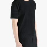 Black top worn by a person, showing the top fit