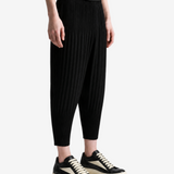 Black pants worn by a person, showing the pants fit