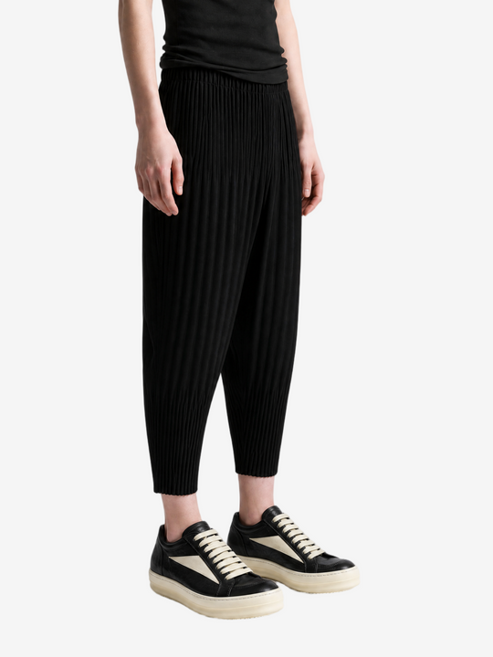 Black pants worn by a person, showing the pants fit