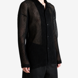 Black shirt worn by a person, showing the shirt fit