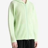 Green jacket worn by a person, showing the jacket fit