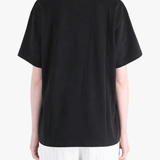 Black top worn by a person, showing the top fit