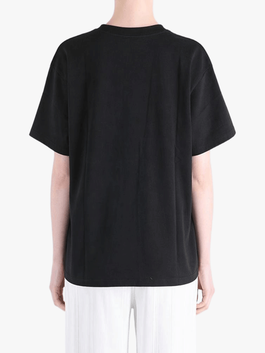 Black top worn by a person, showing the top fit