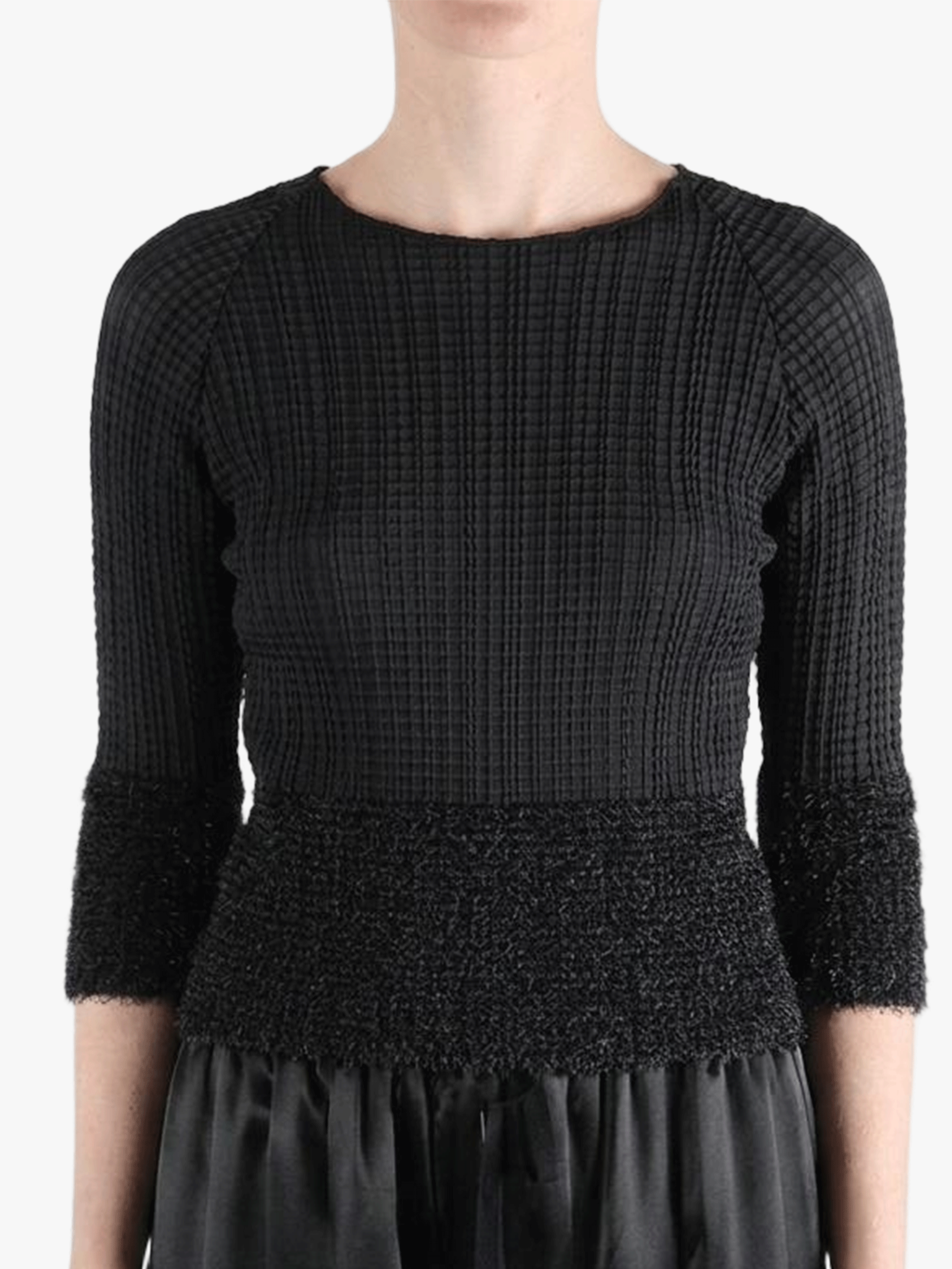 Black knitwear worn by a person,showing the knitwear fit