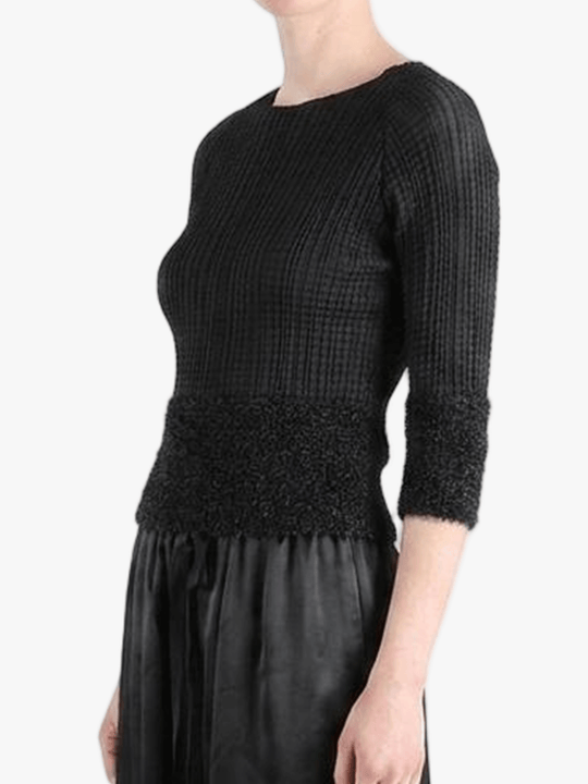Black knitwear worn by a person,showing the knitwear fit