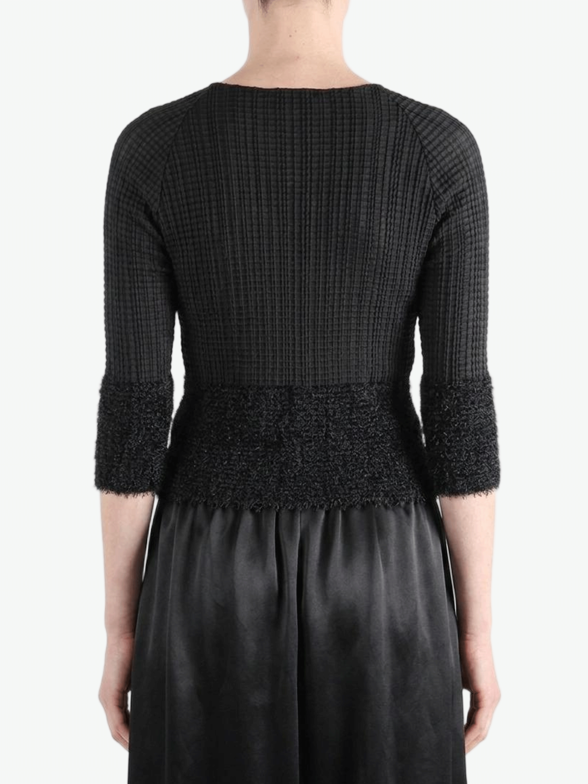 Black knitwear worn by a person,showing the knitwear fit