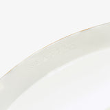Detail of JINJIN PARIS Golden Rim Shallow Plate Medium with subtle “SEATTLE” embossing along the interior rim.
