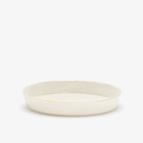 JINJIN PARIS Golden Rim Shallow Plate Medium in ivory porcelain, side view with low profile and hand-finished gold rim.
