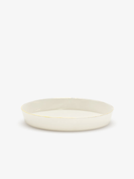JINJIN PARIS Golden Rim Shallow Plate Medium in ivory porcelain, side view with low profile and hand-finished gold rim.