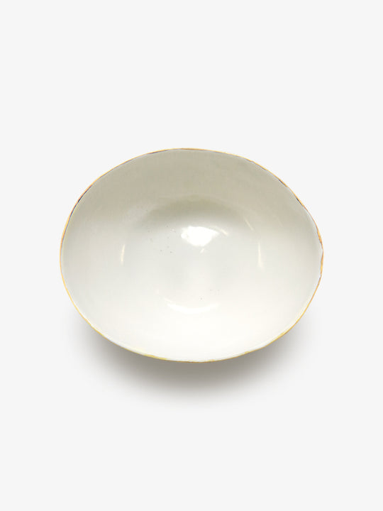 Top view of JINJIN PARIS Golden Rim Bowl Large in glazed ivory porcelain with asymmetrical circular shape and gold edging.