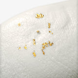 Detail of JINJIN PARIS Golden Rim Bowl Large with textured porcelain surface and scattered gold leaf accents.