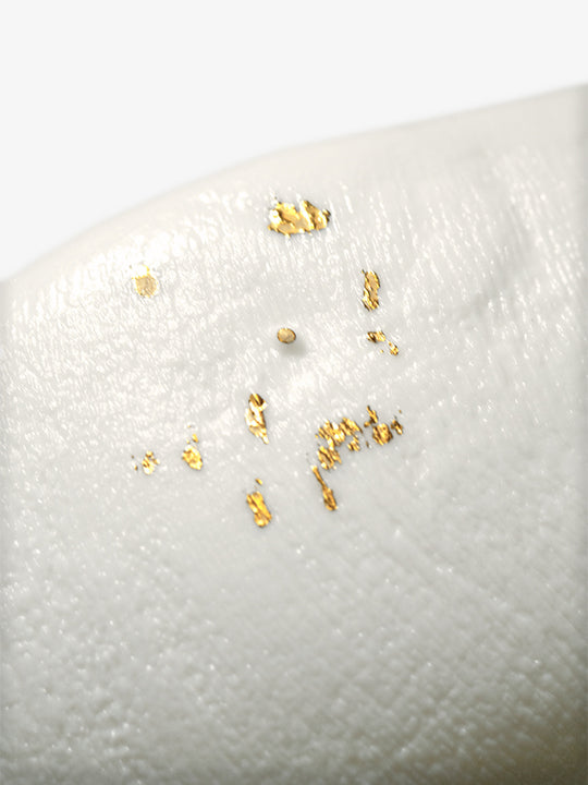 Detail of JINJIN PARIS Golden Rim Bowl Large with textured porcelain surface and scattered gold leaf accents.