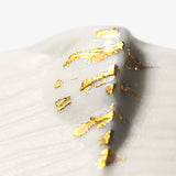 Detail of JINJIN PARIS Golden Rim Coffee Cup Medium with textured porcelain surface and gold leaf accents.