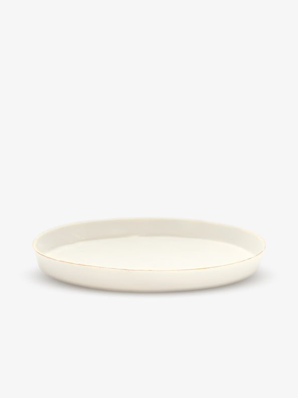JINJIN PARIS Golden Rim Shallow Plate Large in ivory porcelain, side view with low profile and hand-finished gold rim.