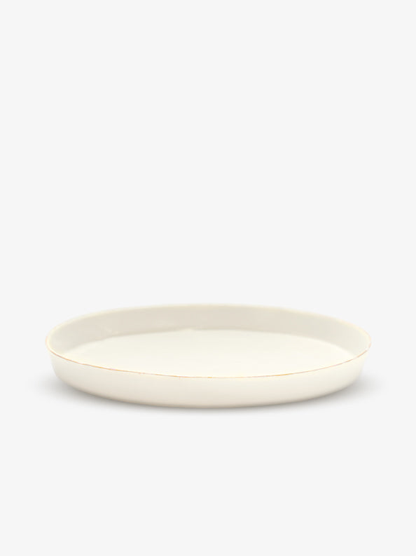 JINJIN PARIS Golden Rim Shallow Plate Large in ivory porcelain, side view with low profile and hand-finished gold rim.