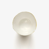 Top view of JINJIN PARIS Golden Rim Teacup Medium with glazed interior and asymmetrical circular opening.