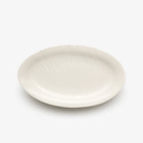 JINJIN PARIS Leaf Oval Plate in ivory porcelain, angled top view showing oval silhouette and botanical detailing.