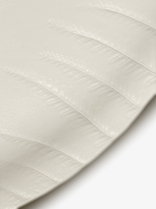Detail of JINJIN PARIS Leaf Oval Plate with embossed leaf vein texture on glazed porcelain surface.