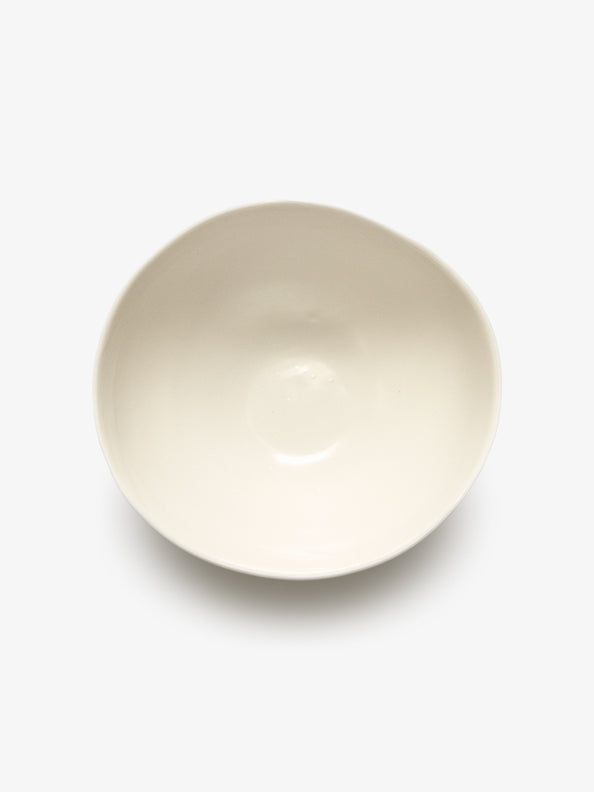 Top view of JINJIN PARIS Pure White Bowl in glazed ivory porcelain with asymmetrical circular shape.