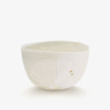 JINJIN PARIS Leaf Whisper Teacup in ivory porcelain, angled view with botanical relief texture and gold leaf accents.