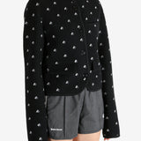 Black jacket worn by a person, showing the jacket fit