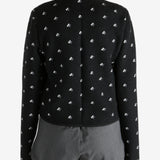 Black jacket worn by a person, showing the jacket fit