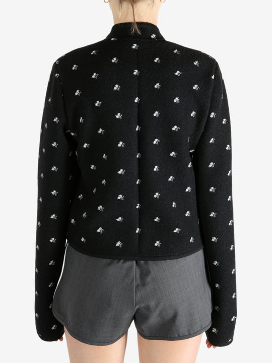 Black jacket worn by a person, showing the jacket fit