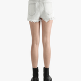 White shorts worn by a person, showing the shorts fit