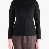 Black knitwear worn by a person, showing the knitwear fit