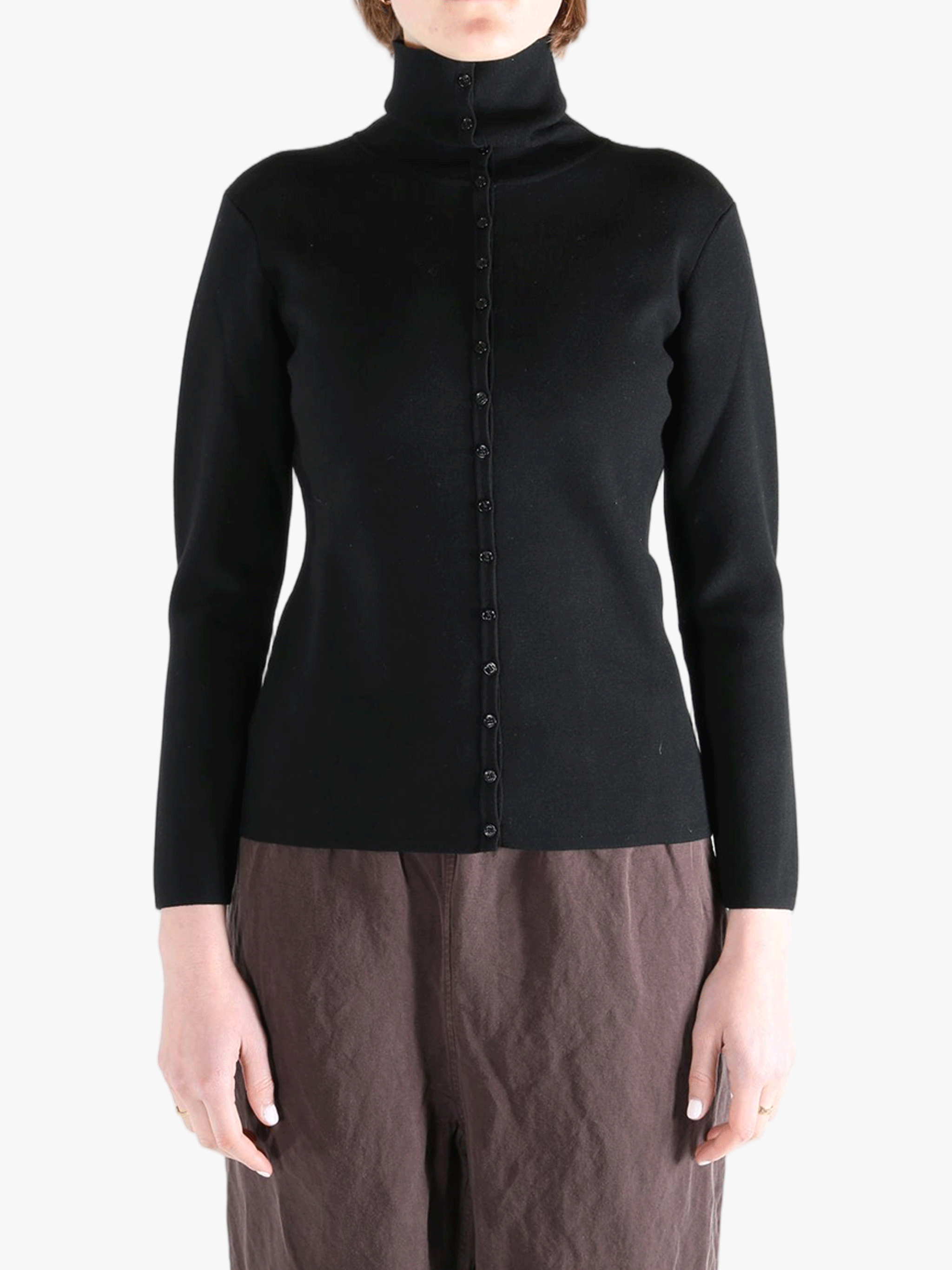 Black knitwear worn by a person, showing the knitwear fit