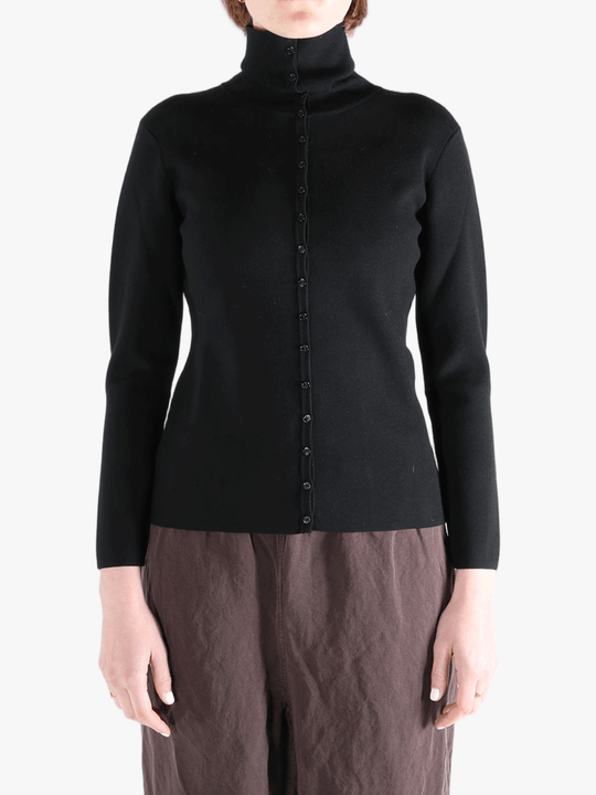 Black knitwear worn by a person, showing the knitwear fit