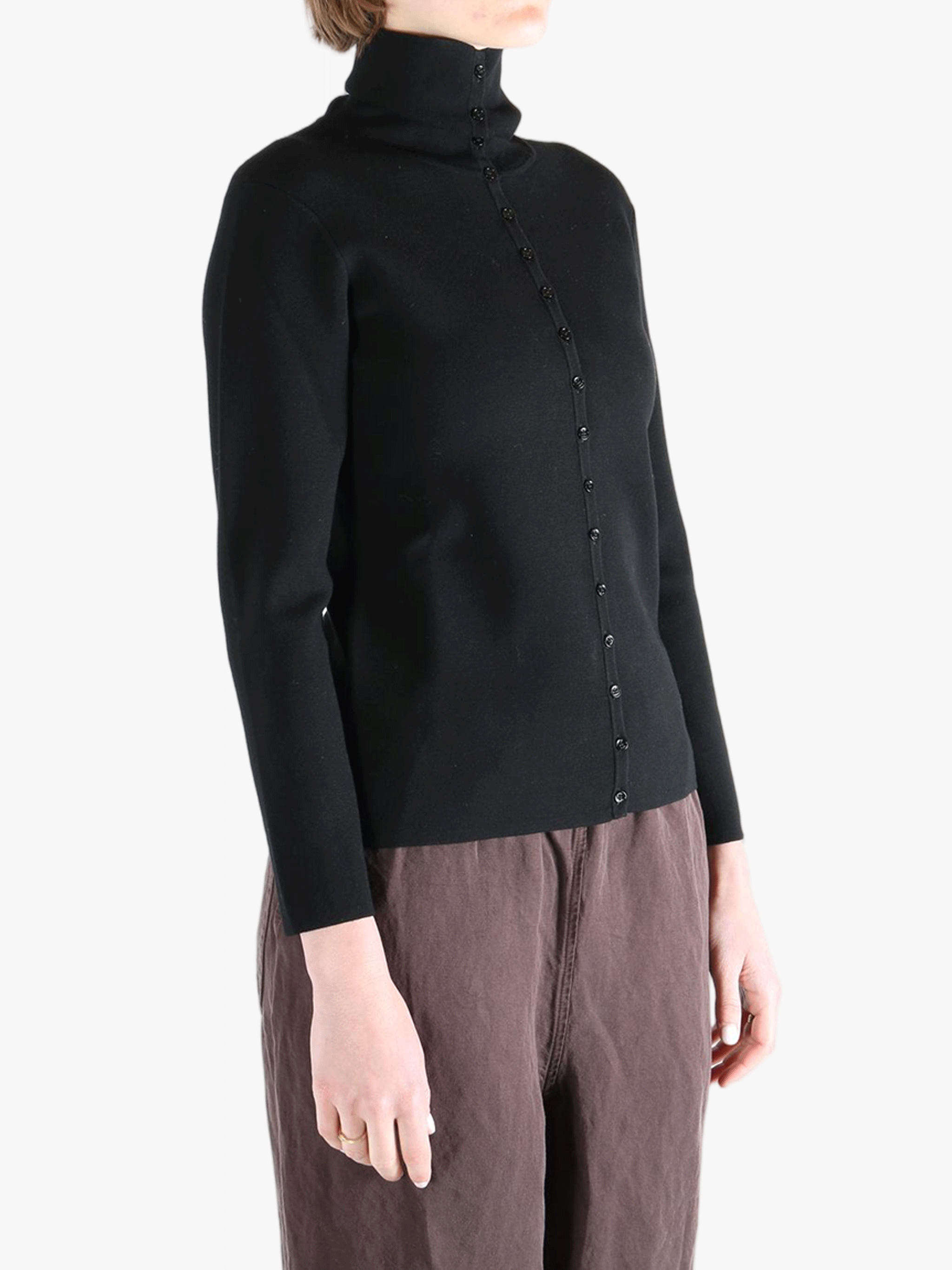 Black knitwear worn by a person, showing the knitwear fit