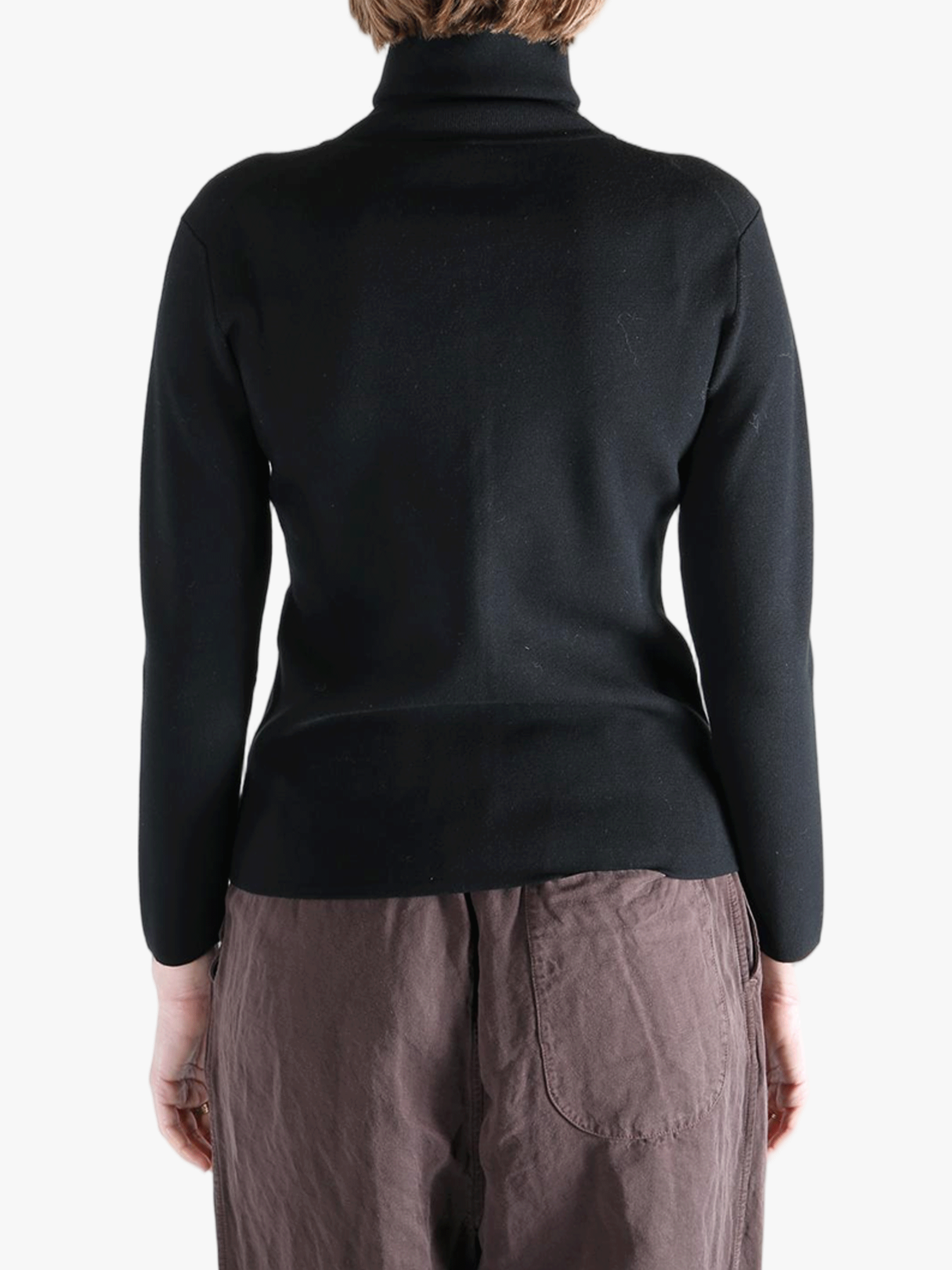 Black knitwear worn by a person, showing the knitwear fit