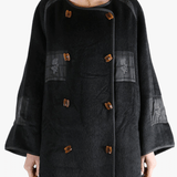 Black jacket worn by a person, showing the jacket fit