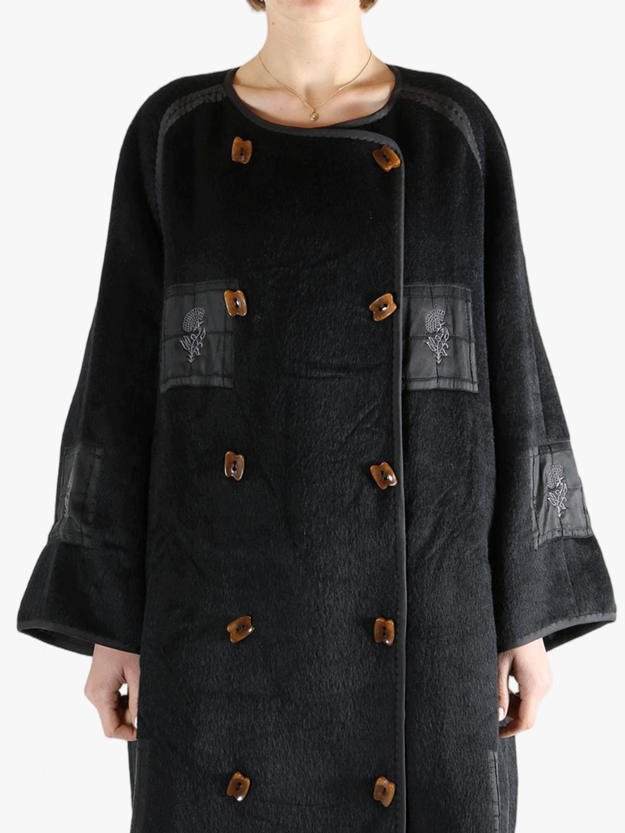 Black jacket worn by a person, showing the jacket fit