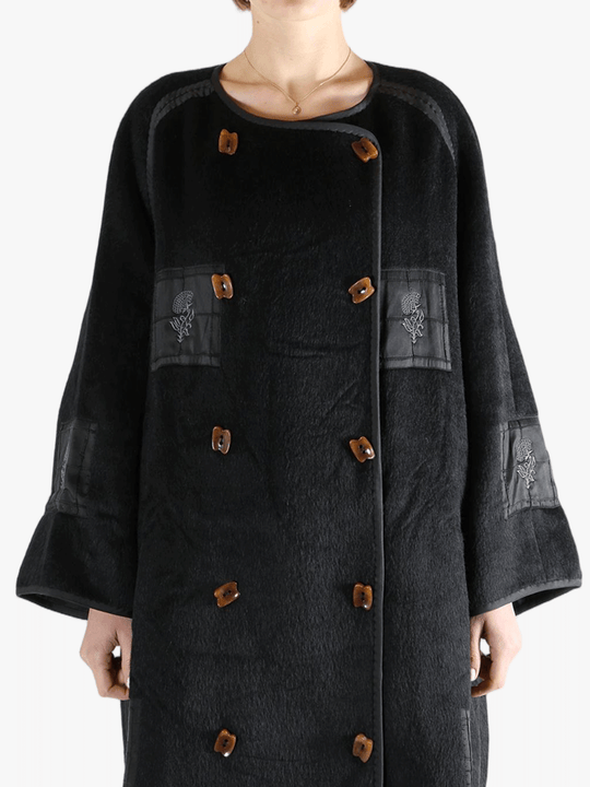 Black jacket worn by a person, showing the jacket fit