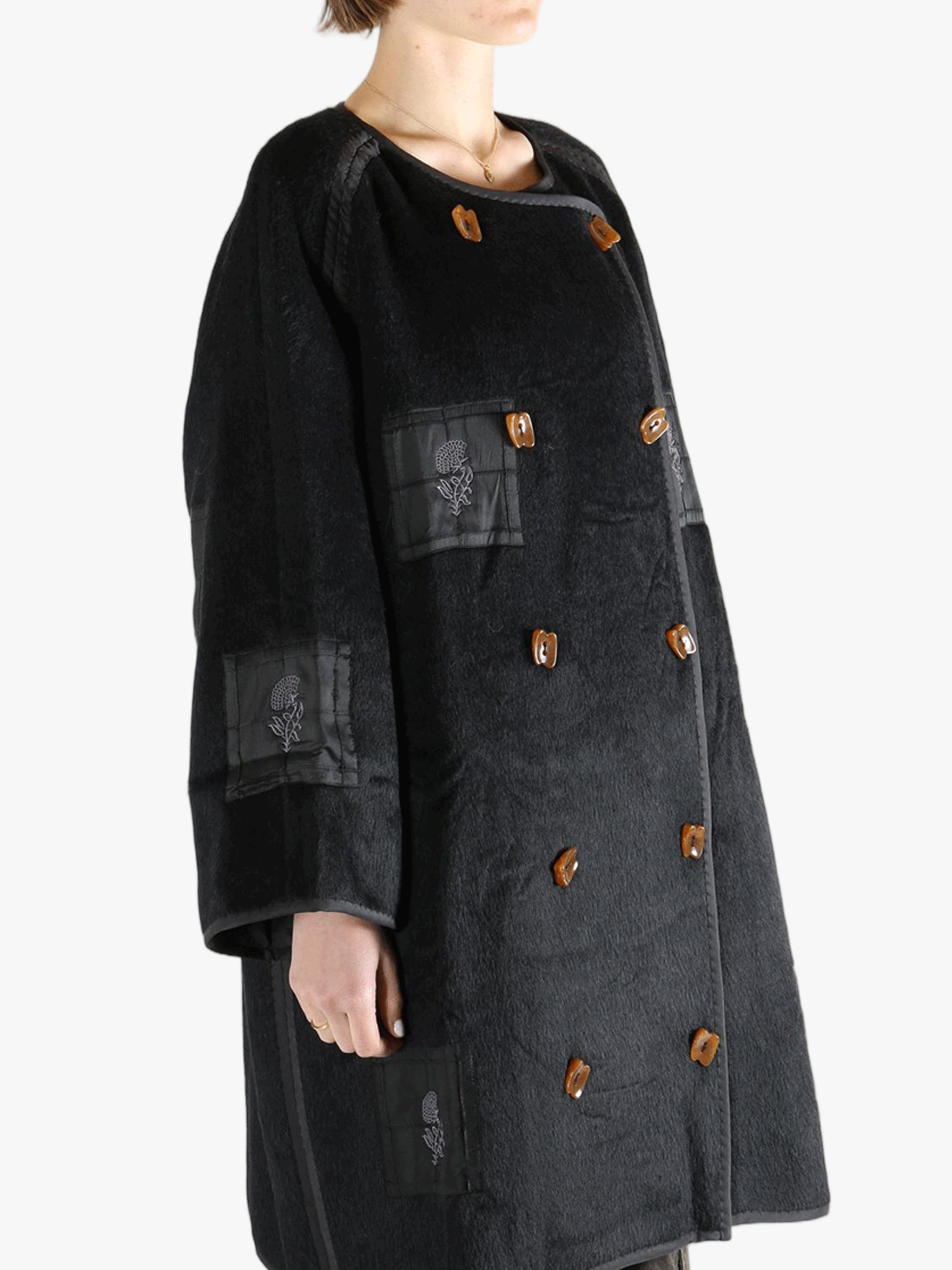 Black jacket worn by a person, showing the jacket fit