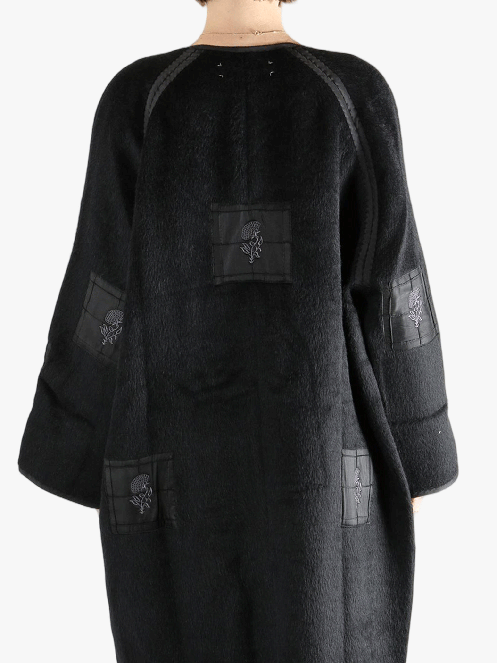 Black jacket worn by a person, showing the jacket fit