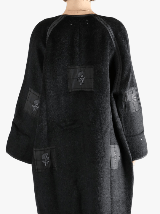 Black jacket worn by a person, showing the jacket fit