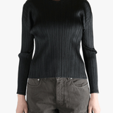 Black shirt worn by a person, showing the shirt fit