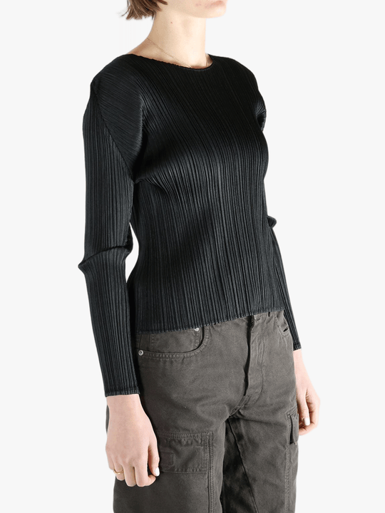 Black shirt worn by a person, showing the shirt fit