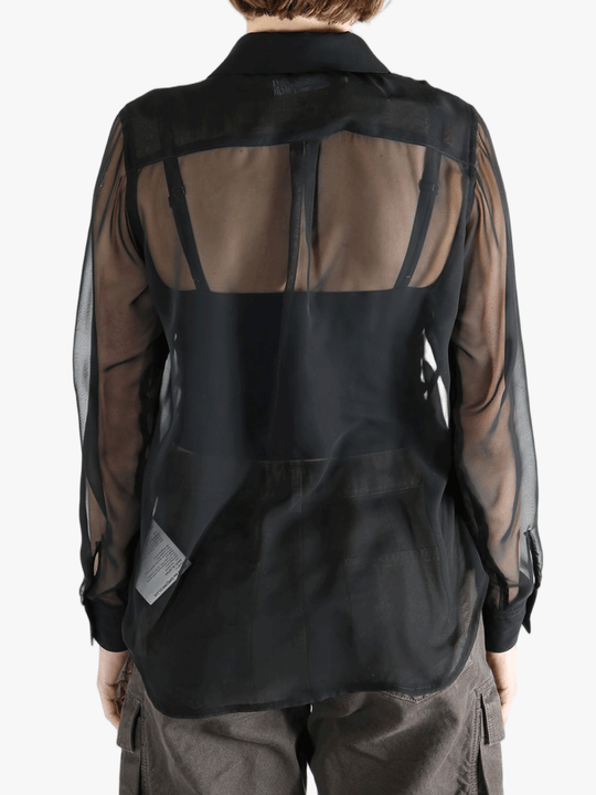 Black shirt  worn by a person, showing the shirt fit